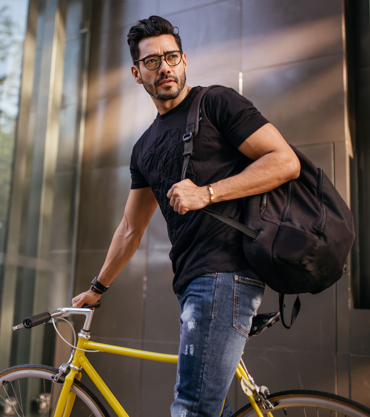 Man on bike with sports bag